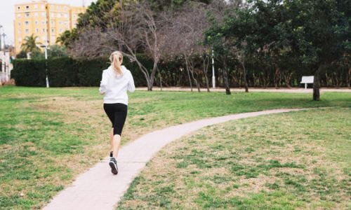 unrecognizable-woman-running-park
