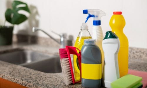 Cleaning-supplies (sponges, cleaners)-on-a -kitchen-counter.