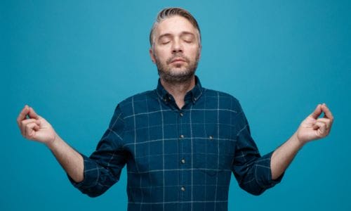 middle-age-man-with-grey-hair-dark-color-shirt-looking-relaxed-calm-meditating-