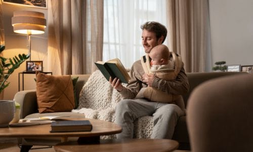 full-shot-father-holding-baby-reading