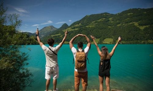 young-people-looking-at-the-lake-with-thier-hands-up