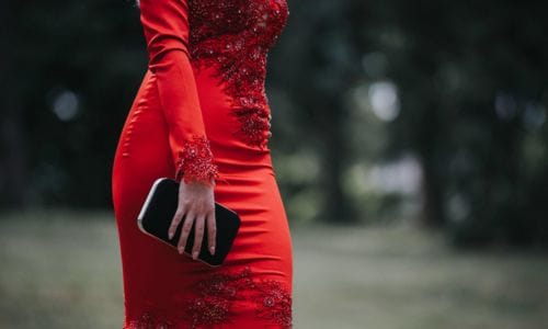 Female-wearing-a-red-sexy-tight-dress-and-holding-a-purse