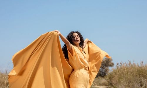 Portrait-of-joyful-woman-with-yellow-cloth in-nature
